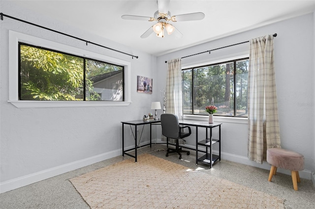 home office featuring speckled floor, baseboards, and a ceiling fan