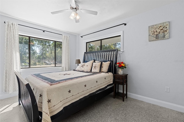 bedroom with a ceiling fan, baseboards, and multiple windows