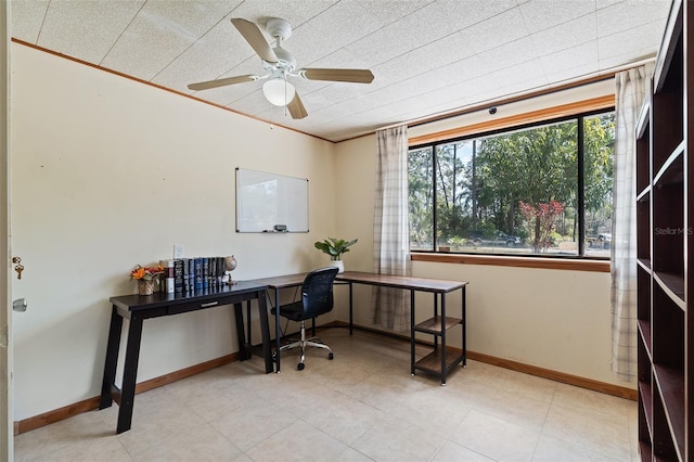 office area featuring a ceiling fan and baseboards