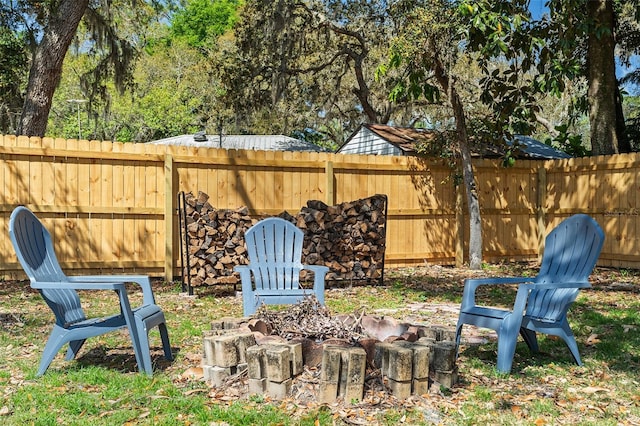 view of yard featuring a fire pit and fence
