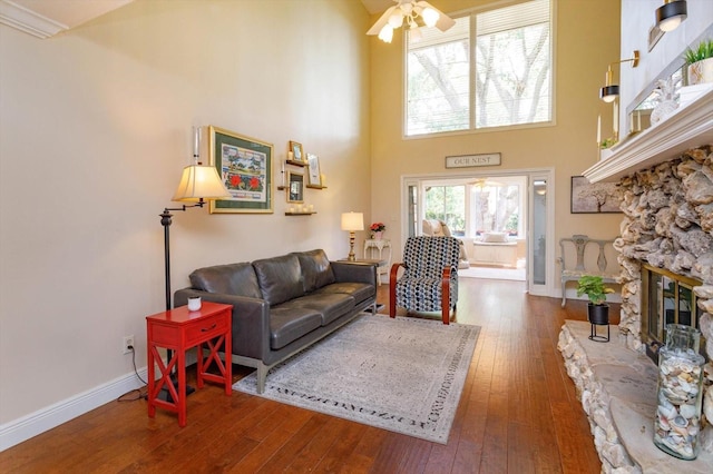 487 Oak Haven Dr Unit 487, Altamonte Springs, FL 32701 - living area with a fireplace, wood-type flooring, a ceiling fan, baseboards, and a towering ceiling