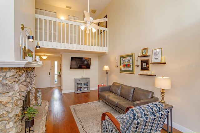 487 Oak Haven Dr Unit 487, Altamonte Springs, FL 32701 - living room with a fireplace, wood-type flooring, a ceiling fan, baseboards, and a towering ceiling