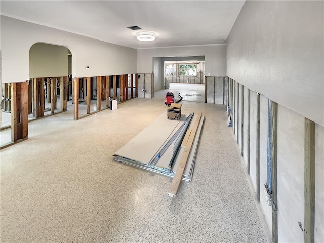 2826 46th St S, Gulfport, FL 33711 - miscellaneous room with visible vents, crown molding, arched walkways, and speckled floor