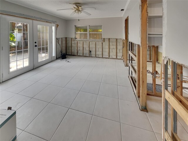 2826 46th St S, Gulfport, FL 33711 - spare room featuring french doors, ornamental molding, tile patterned floors, a ceiling fan, and wainscoting