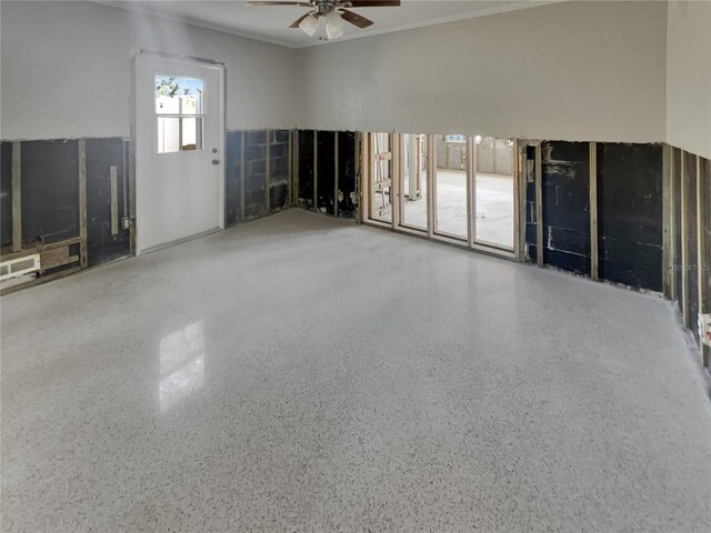 2826 46th St S, Gulfport, FL 33711 - unfurnished living room with visible vents, crown molding, speckled floor, and a ceiling fan