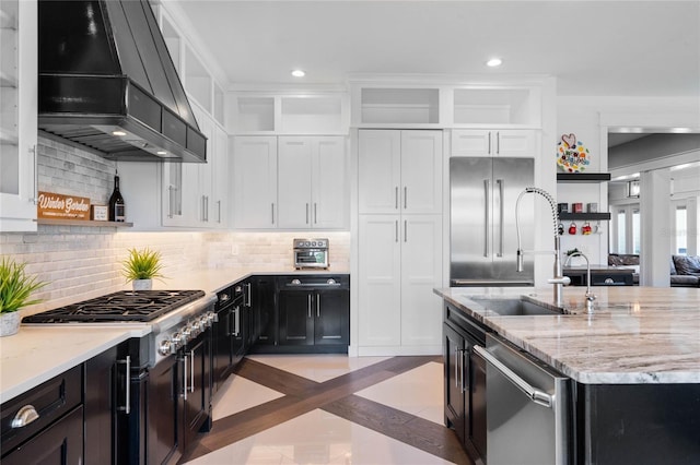 1224 Union Club Dr, Winter Garden, FL 34787 - kitchen featuring appliances with stainless steel finishes, premium range hood, a sink, open shelves, and tasteful backsplash