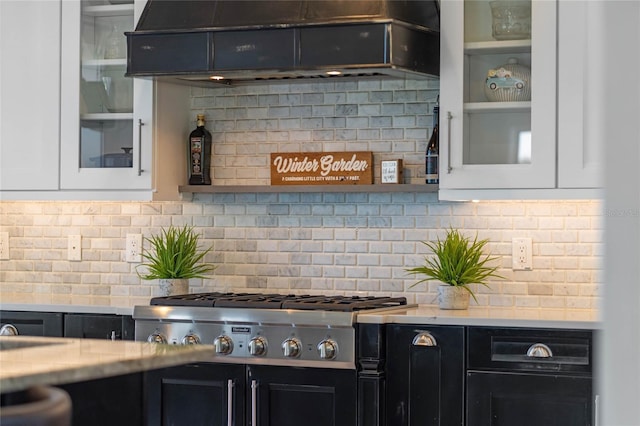 1224 Union Club Dr, Winter Garden, FL 34787 - kitchen featuring stainless steel gas stovetop, dark cabinets, light countertops, white cabinetry, and decorative backsplash