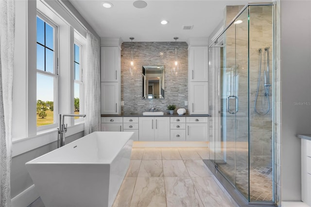 1224 Union Club Dr, Winter Garden, FL 34787 - bathroom featuring vanity, a freestanding bath, a shower stall, recessed lighting, and marble finish flooring