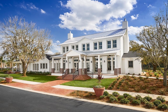 1224 Union Club Dr, Winter Garden, FL 34787 - view of front of property with a chimney, a standing seam roof, and a front yard