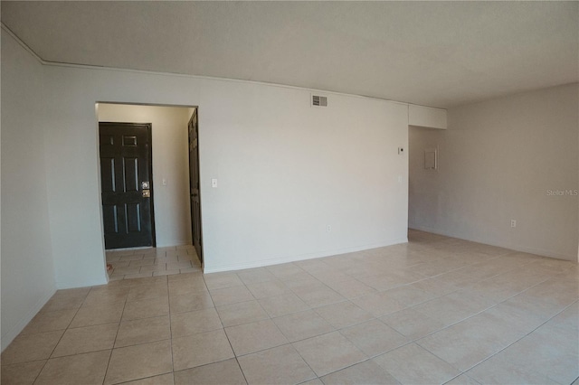 unfurnished room with visible vents and light tile patterned floors