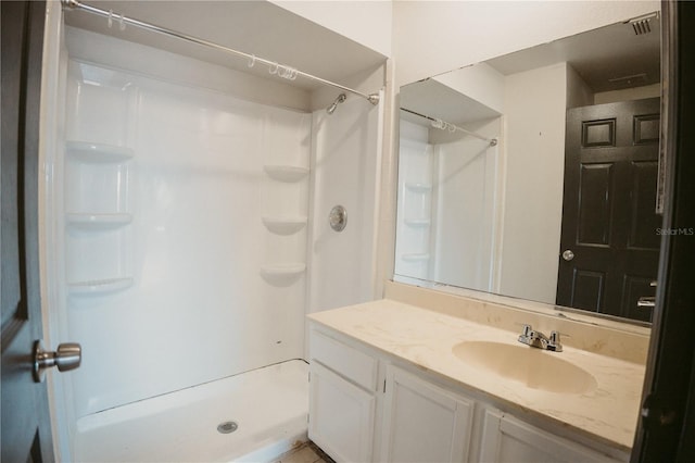 full bath with a shower stall and vanity