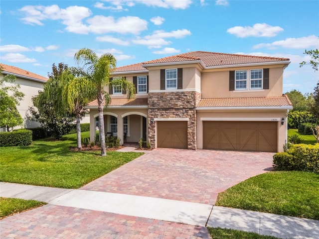 11826 Fiore Dr, Orlando, FL 32827 - mediterranean / spanish-style home with stucco siding, a front lawn, a tiled roof, and decorative driveway