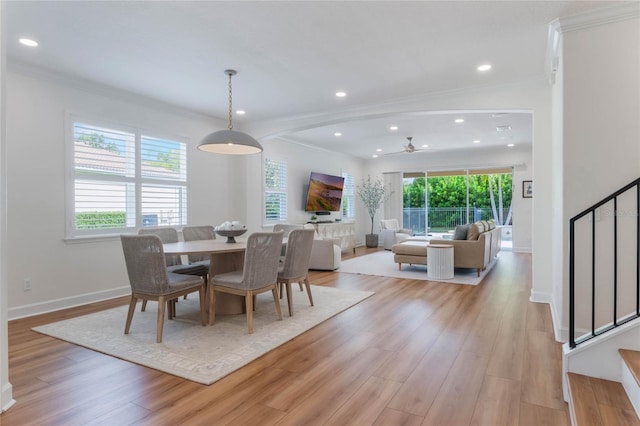11826 Fiore Dr, Orlando, FL 32827 - dining space featuring light wood-style flooring, crown molding, stairs, and ceiling fan
