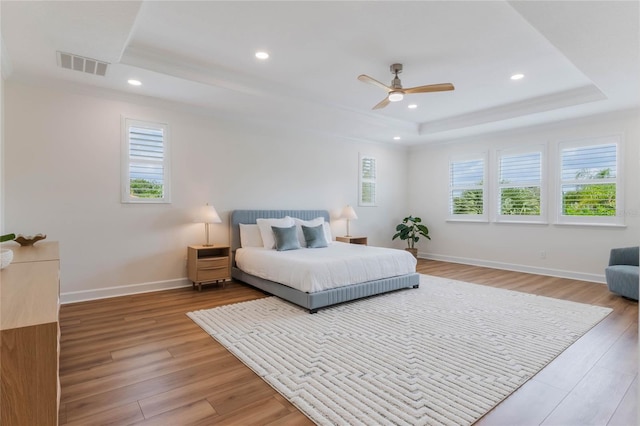 11826 Fiore Dr, Orlando, FL 32827 - bedroom with a tray ceiling, multiple windows, and visible vents