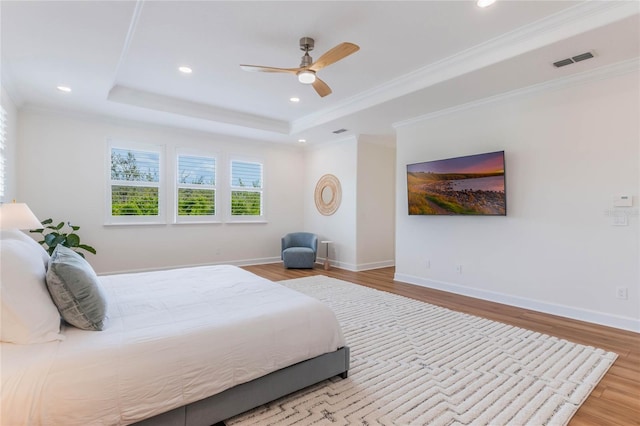 11826 Fiore Dr, Orlando, FL 32827 - bedroom with baseboards, visible vents, wood finished floors, and a raised ceiling