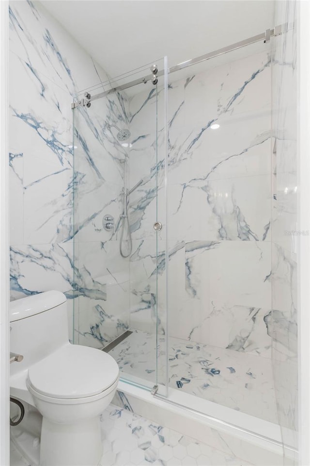 11826 Fiore Dr, Orlando, FL 32827 - bathroom with marble finish floor, a marble finish shower, and toilet