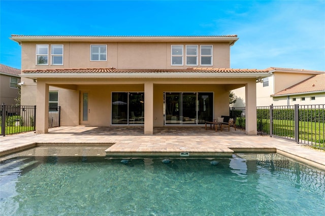 11826 Fiore Dr, Orlando, FL 32827 - rear view of house featuring fence, a tile roof, and a patio area