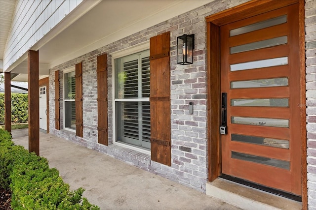 201 Cedarwood Dr, Maitland, FL 32751 - doorway to property featuring covered porch and brick siding