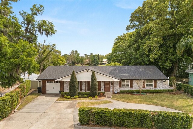 201 Cedarwood Dr, Maitland, FL 32751 - view of front of house with brick siding, concrete driveway, an attached garage, and a front lawn