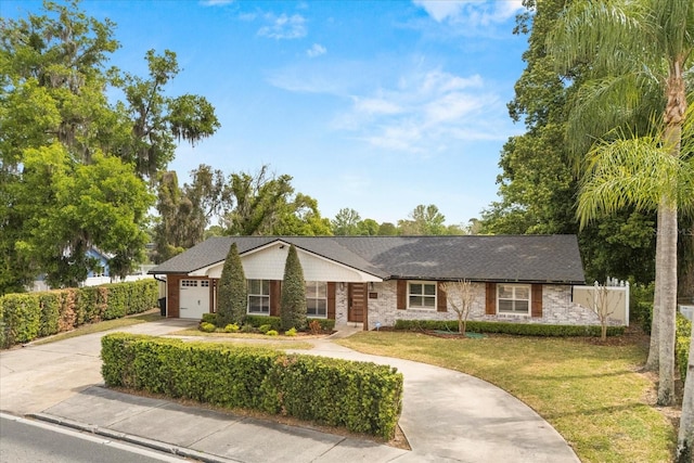 201 Cedarwood Dr, Maitland, FL 32751 - ranch-style house with a front lawn, a garage, brick siding, and concrete driveway