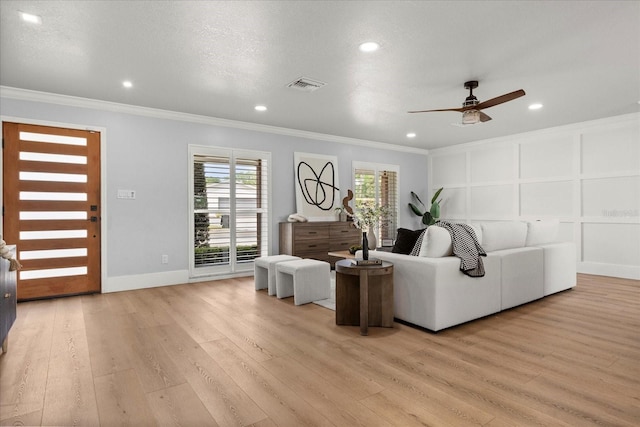 201 Cedarwood Dr, Maitland, FL 32751 - living room with visible vents, crown molding, and light wood-style flooring