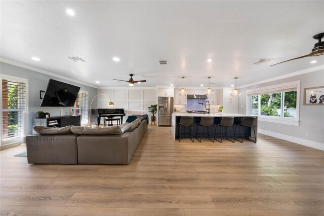 201 Cedarwood Dr, Maitland, FL 32751 - living area with visible vents, light wood-type flooring, and ornamental molding