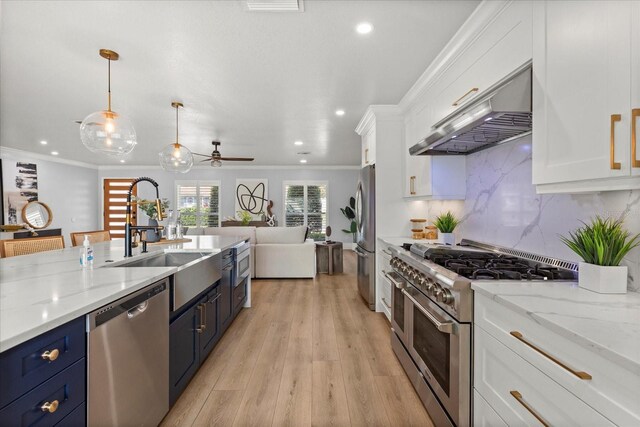 201 Cedarwood Dr, Maitland, FL 32751 - kitchen with blue cabinetry, stainless steel appliances, under cabinet range hood, a sink, and white cabinets
