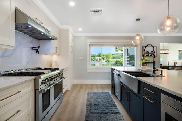201 Cedarwood Dr, Maitland, FL 32751 - kitchen with a sink, under cabinet range hood, stainless steel appliances, visible vents, and ornamental molding