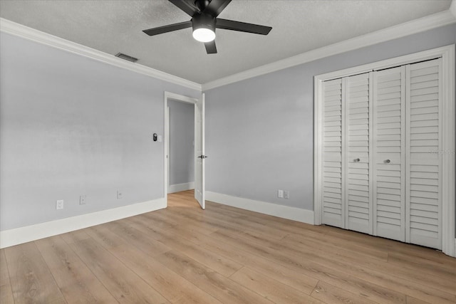 201 Cedarwood Dr, Maitland, FL 32751 - unfurnished bedroom featuring a textured ceiling, baseboards, visible vents, light wood-style floors, and ornamental molding
