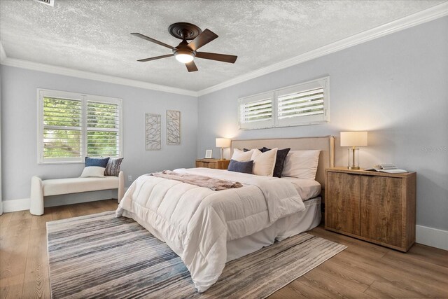 201 Cedarwood Dr, Maitland, FL 32751 - bedroom with crown molding, a textured ceiling, and wood finished floors