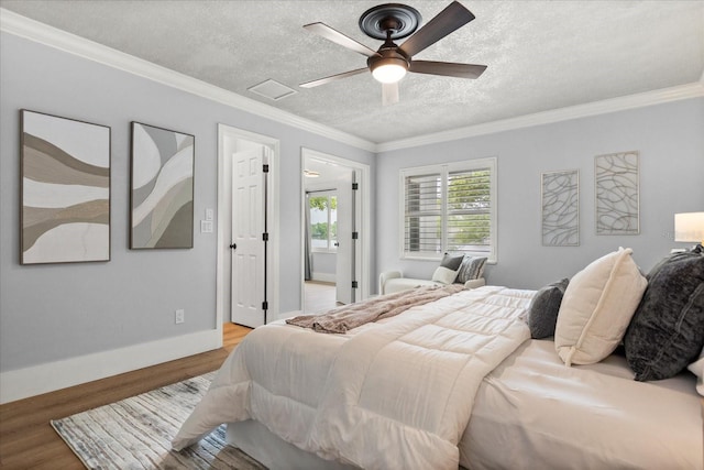 201 Cedarwood Dr, Maitland, FL 32751 - bedroom featuring crown molding, baseboards, a textured ceiling, and light wood-type flooring