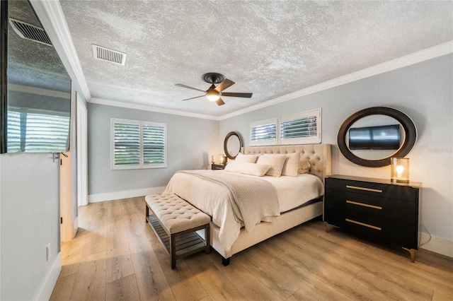 201 Cedarwood Dr, Maitland, FL 32751 - bedroom featuring ornamental molding, baseboards, a textured ceiling, light wood finished floors, and visible vents