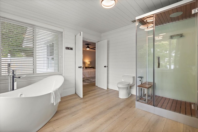 201 Cedarwood Dr, Maitland, FL 32751 - bathroom with toilet, a shower stall, ensuite bath, ceiling fan, and wood finished floors