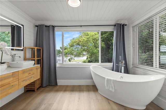 201 Cedarwood Dr, Maitland, FL 32751 - full bath with a freestanding tub, wood ceiling, vanity, and hardwood / wood-style floors