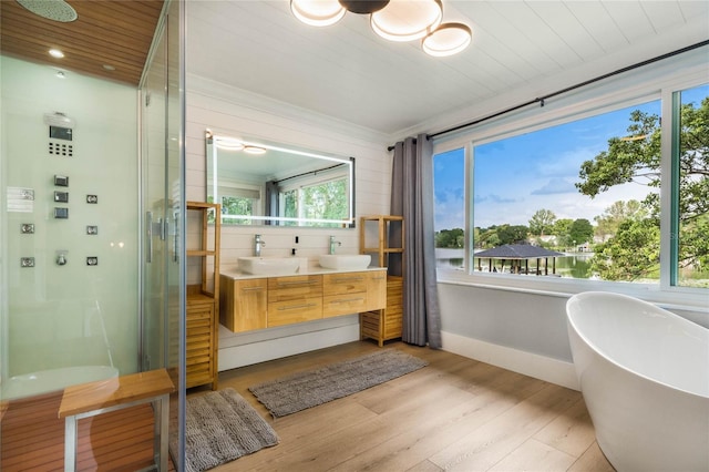 201 Cedarwood Dr, Maitland, FL 32751 - full bath featuring double vanity, a sink, a stall shower, and wood finished floors