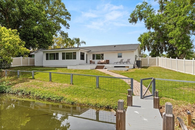 201 Cedarwood Dr, Maitland, FL 32751 - back of property featuring a fenced backyard, a lawn, a gate, and a deck with water view