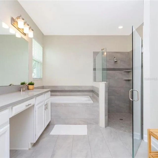 14711 Winter Stay Dr, Winter Garden, FL 34787 - bathroom featuring a tile shower, a bath, tile patterned flooring, and vanity