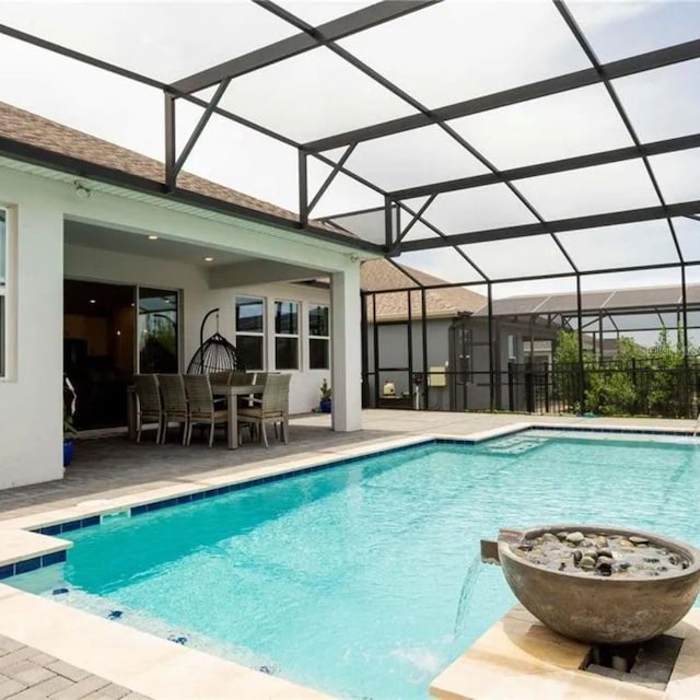 14711 Winter Stay Dr, Winter Garden, FL 34787 - swimming pool with a patio area, glass enclosure, and outdoor dining space