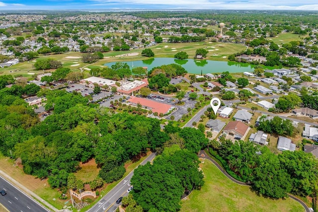 birds eye view of property with view of golf course, a residential view, and a water view
