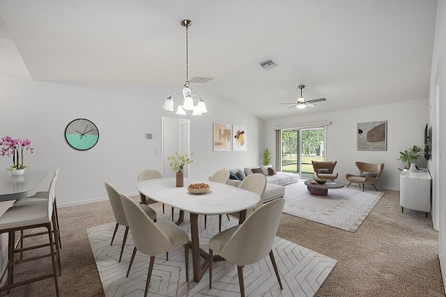 dining space with lofted ceiling, light colored carpet, ceiling fan with notable chandelier, baseboards, and visible vents