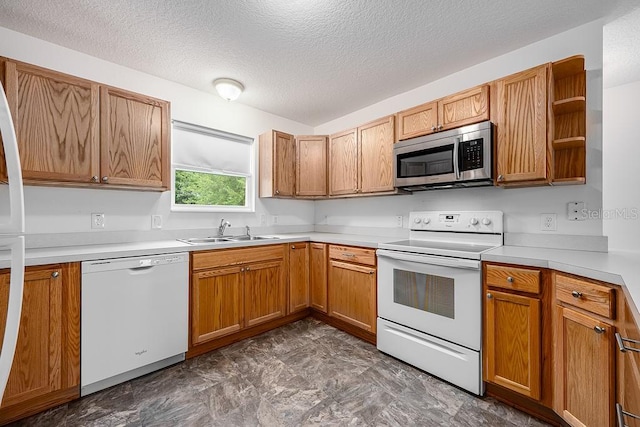 kitchen with a textured ceiling, light countertops, white appliances, a sink, and open shelves
