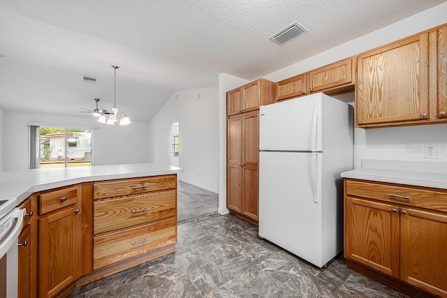 kitchen with light countertops, lofted ceiling, a wealth of natural light, freestanding refrigerator, and visible vents
