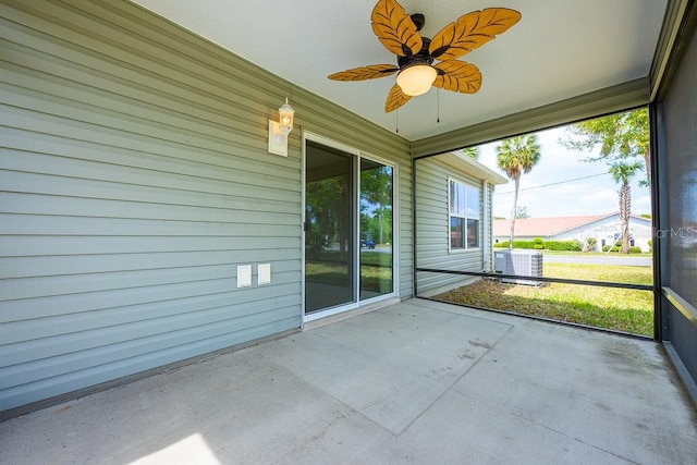 unfurnished sunroom with ceiling fan