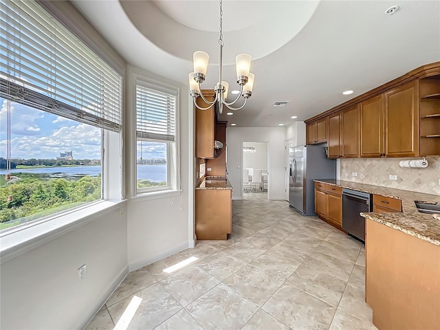 8743 S The Esplanade Unit 18, Orlando, FL 32836 - kitchen with stainless steel appliances, plenty of natural light, backsplash, open shelves, and recessed lighting