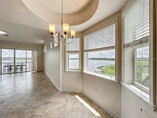 8743 S The Esplanade Unit 18, Orlando, FL 32836 - unfurnished dining area with a water view, a chandelier, and light tile patterned flooring