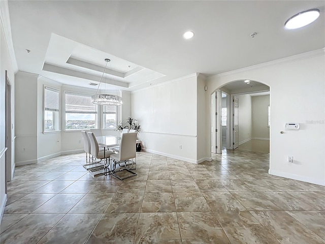 8743 S The Esplanade Unit 18, Orlando, FL 32836 - dining area featuring arched walkways, healthy amount of natural light, crown molding, a chandelier, and a raised ceiling