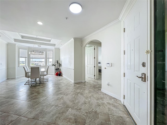 8743 S The Esplanade Unit 18, Orlando, FL 32836 - dining area with arched walkways, a tray ceiling, crown molding, and light tile patterned floors