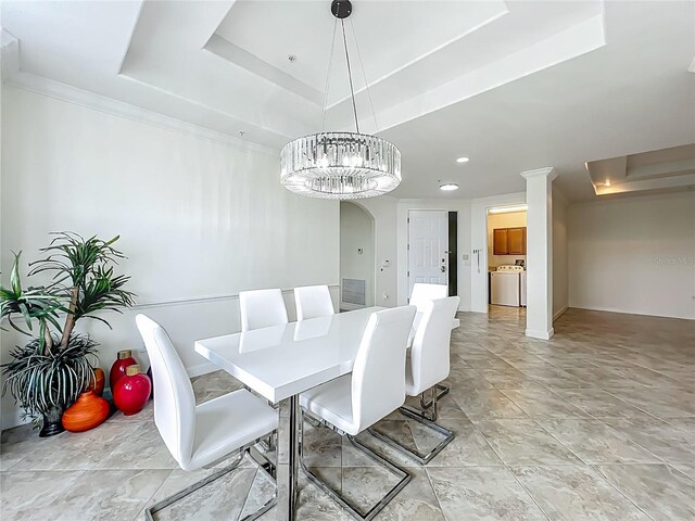 8743 S The Esplanade Unit 18, Orlando, FL 32836 - dining space with a tray ceiling, washer / clothes dryer, and a chandelier