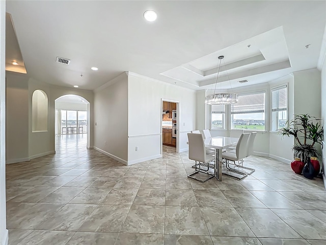 8743 S The Esplanade Unit 18, Orlando, FL 32836 - dining area with healthy amount of natural light, a chandelier, arched walkways, recessed lighting, and a raised ceiling