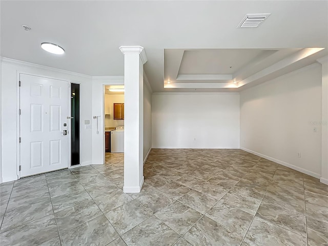 8743 S The Esplanade Unit 18, Orlando, FL 32836 - entrance foyer with washer / clothes dryer, a tray ceiling, and ornamental molding